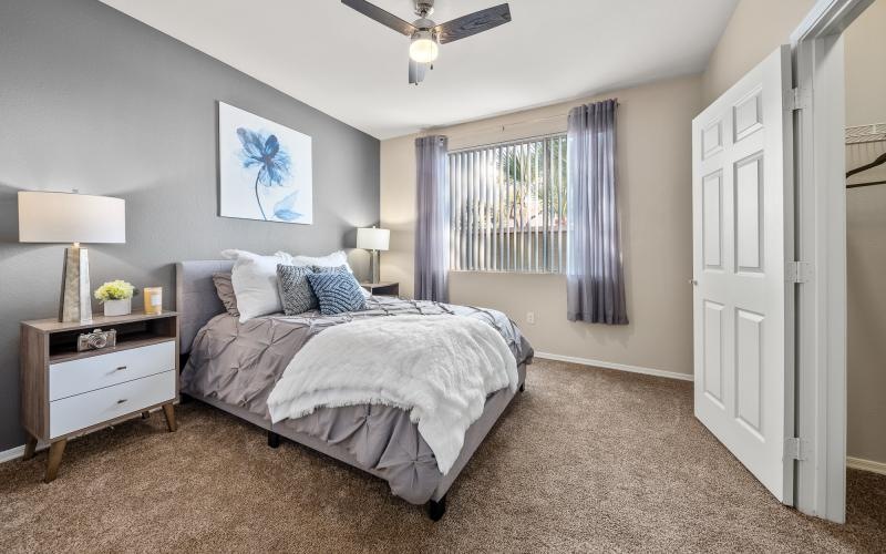 a bedroom with a bed and a fan